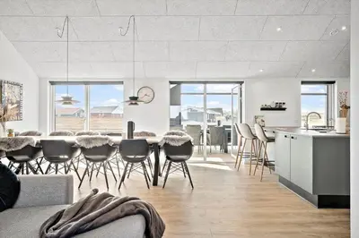 a kitchen and living room with a table and chairs at 272-Harboore-Neerlandiavej-196 in Harboør