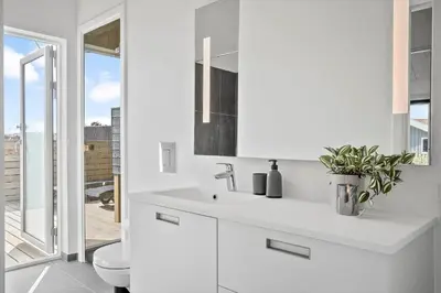 a white bathroom with a sink and a toilet at 272-Harboore-Neerlandiavej-196 in Harboør