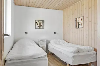 two beds in a room with white walls at 114-Harboore-Strandvejen-164 in Harboør