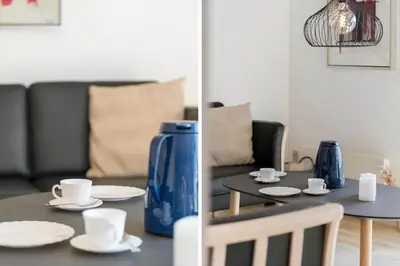 a living room with a table with cups and saucers at 114-Harboore-Strandvejen-164 in Harboør
