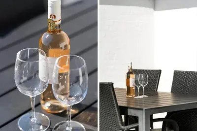 a bottle of wine sitting on a table with wine glasses at 114-Harboore-Strandvejen-164 in Harboør