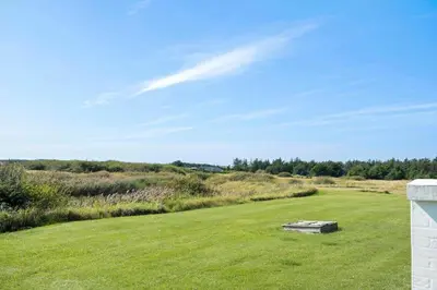 a grassy field with a table in the middle of it at 114-Harboore-Strandvejen-164 in Harboør