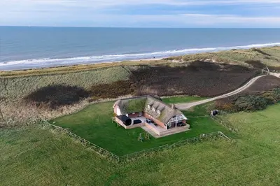 an aerial view of a house on the beach at 181-Harboore-Vejlby-Klit-78 in Harboør