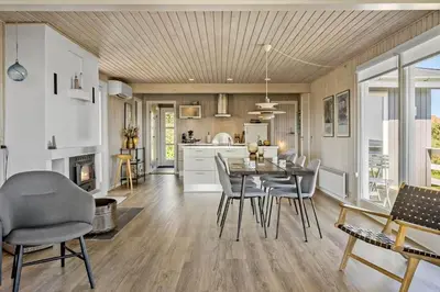 a kitchen and dining room with a table and chairs at G319-Lemvig-Violvej-19 in Lemvig