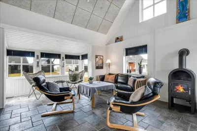 a living room with a couch and a fireplace at 715-Thyboron-Limfjordsvej-17-a in Thyborøn