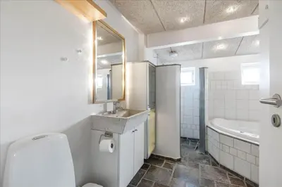a bathroom with a toilet and a sink and a tub at 715-Thyboron-Limfjordsvej-17-a in Thyborøn