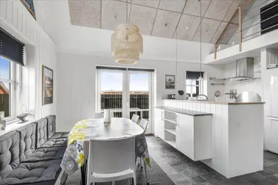 a kitchen with a table and a dining room at 715-Thyboron-Limfjordsvej-17-a in Thyborøn