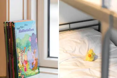 a book and a toy duck sitting on a bed at 370-Harboore-Strandvejen-53 in Harboør
