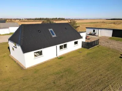 an overhead view of a white house with a black roof at 370-Harboore-Strandvejen-53 in Harboør