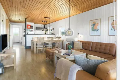 a living room with a couch and a table at 182-Harboore-Vejlby-Klit-153-a in Harboør