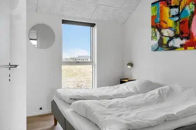 two beds in a white room with a window at 368-Harboore-Gloryvej-25 in Harboør