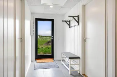 a hallway with a door with a view of a field at 260-Harboore-Strandvejen-158-C in Harboør