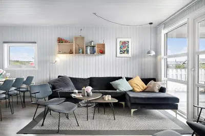 a living room with a couch and tables and chairs at 281-Harboore-Vejlby-Klit-27 in Harboør