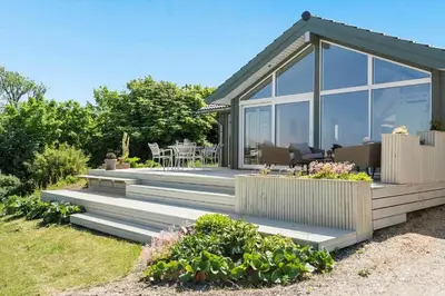 a house with a deck with a patio at G302-Lemvig-Skovstjernevej-2 in Lemvig