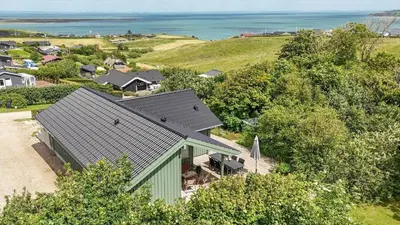an aerial view of a house with the ocean in the background at G302-Lemvig-Skovstjernevej-2 in Lemvig