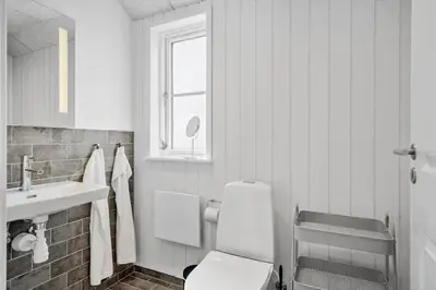 a white bathroom with a toilet and a sink at G509-Lemvig-Myntevej-9 in Lemvig
