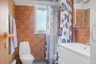 a bathroom with a toilet and a tub and a sink at G192-Lemvig-Violvej-92 in Lemvig