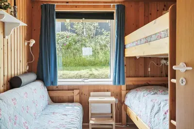 a small bedroom with a bunk bed and a window at G192-Lemvig-Violvej-92 in Lemvig