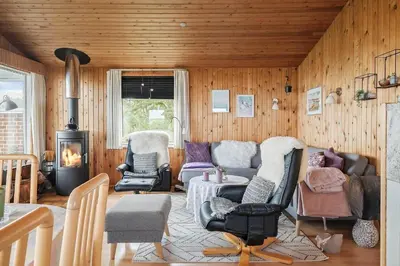 a living room with a couch and chairs and a stove at G192-Lemvig-Violvej-92 in Lemvig