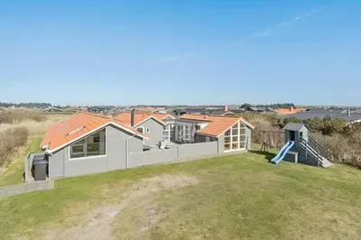 a house on top of a hill with a playground at 149-Harboore-Vejlby-Klit-175 in Harboør