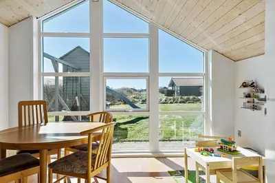 a dining room with a table and a large window at 149-Harboore-Vejlby-Klit-175 in Harboør