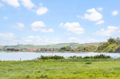 a body of water with a city in the background at 605-Lemvig-Gjelleroddevej-65 in Lemvig