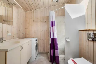 a bathroom with a sink and a washing machine at 605-Lemvig-Gjelleroddevej-65 in Lemvig