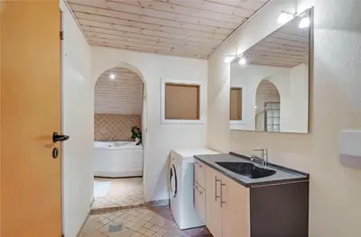 a bathroom with a sink and a bath tub at 145-Harboore-Neerlandiavej-98 in Harboør