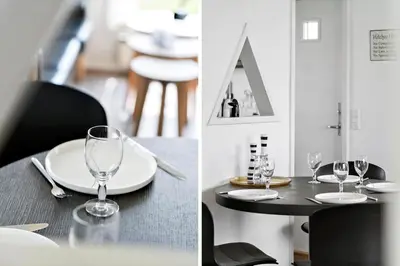 a table with glasses on it and a table with chairs at G103-Lemvig-Klovervej-3 in Lemvig