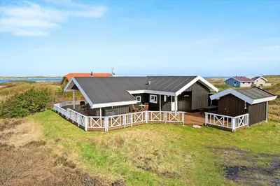 a large house with a deck on a field at 510-Lemvig-Lyngsletten-28 in Lemvig