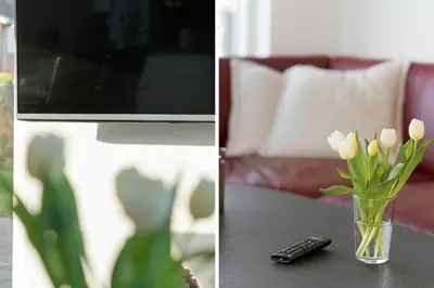 a vase of flowers on a table with a remote control at G331-Lemvig-Myntevej-31 in Lemvig