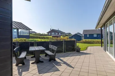 a patio with two benches and a picnic table at G331-Lemvig-Myntevej-31 in Lemvig