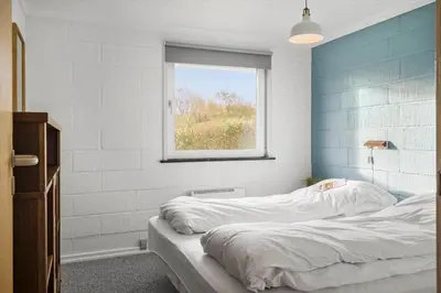a bedroom with two beds and a window at G113-Lemvig-Nellikevej-13 in Lemvig