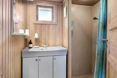 a bathroom with a white sink and a window at G171-Lemvig-Porsevej-71 in Lemvig