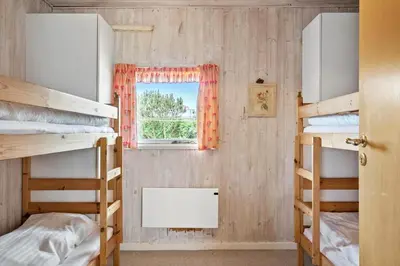 a room with three bunk beds and a window at 121-Harboore-Vejlby-Klit-173-a in Harboør