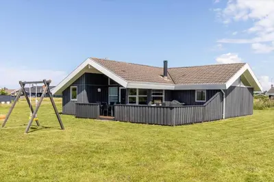 a house with a swing and a playground at 179-Harboore-Neerlandiavej-206 in Harboør