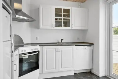 a white kitchen with white cabinets and a sink at 325-Harboore-Skalvej-4-c in Harboør