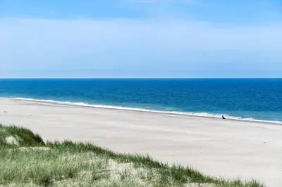 an empty beach with the ocean in the background at 325-Harboore-Skalvej-4-c in Harboør