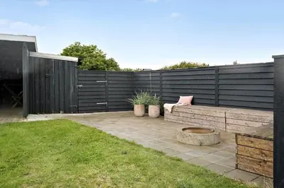 a backyard with a bench and a fence at 273-Harboore-Neerlandiavej-146 in Harboør
