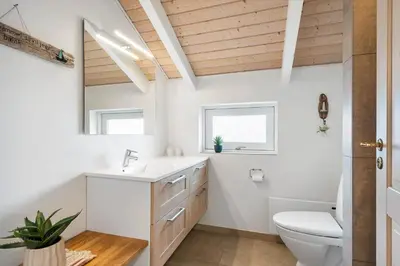 a bathroom with a white sink and a toilet at 267-Harboore-Vaermlandvej-10 in Harboør