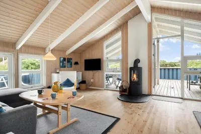 a living room with a wood burning stove in it at 267-Harboore-Vaermlandvej-10 in Harboør