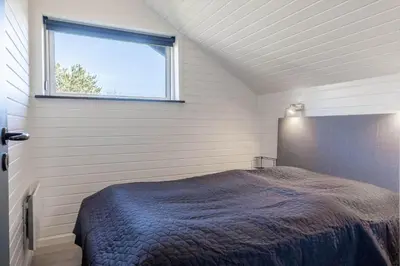 a bedroom with a bed and a window at G246-Lemvig-Skovstjernevej-57 in Lemvig