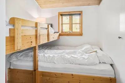 a bedroom with a bunk bed and a window at G217-Lemvig-Violvej-17 in Lemvig