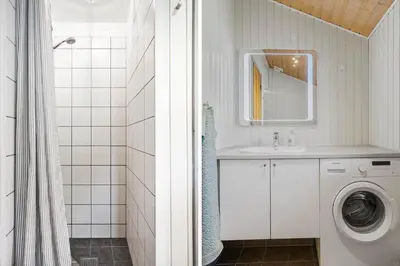 a bathroom with a washing machine and a sink at G217-Lemvig-Violvej-17 in Lemvig