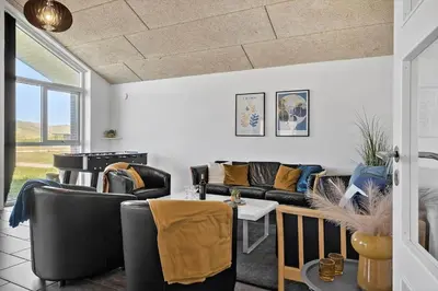 a living room with couches and a table at 305-Harboore-Arcticvej-6 in Harboør