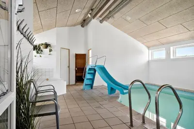 a indoor pool with a slide in a house at 305-Harboore-Arcticvej-6 in Harboør