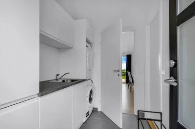 a white kitchen with a sink and a dishwasher at G307-Lemvig-Bynkevej-7 in Lemvig