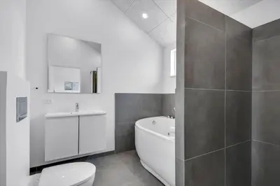 a bathroom with a tub and a toilet and a sink at G307-Lemvig-Bynkevej-7 in Lemvig