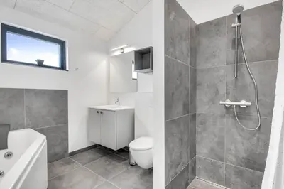 a bathroom with a shower and a toilet and a sink at 255-Harboore-Vejlby-Klit-37-A in Harboør