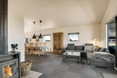 a living room with a couch and a fireplace at 100-Harboore-Vejlby-Klit-51 in Harboør